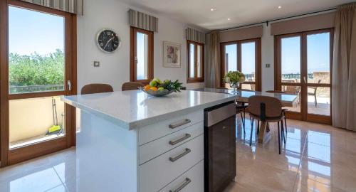 a kitchen with a large island with a counter top at 3 bedroom Villa Melandra with private pool and sea views, Aphrodite Hills Resort in Kouklia