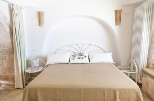 A bed or beds in a room at Masseria Lacatena