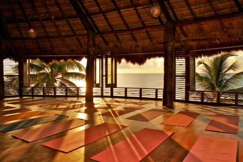 a room with a floor with a view of the ocean at Amansala Resort in Tulum