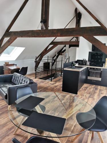 a living room with black chairs and a table at Gite du Panty in Saint-Tricat
