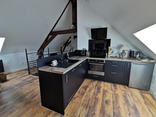 a kitchen with a sink and a stove at Gite du Panty in Saint-Tricat