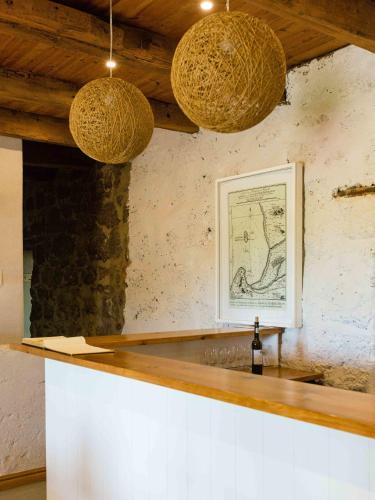 a bar with two lights hanging over a counter at Strandveld Vineyards Cottages in Elim