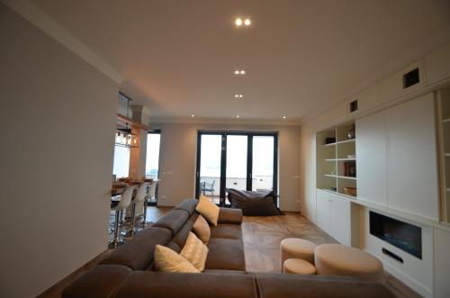 a living room with a brown couch and a table at Le Terrazze, Via Selvalunga 1, Stresa in Stresa