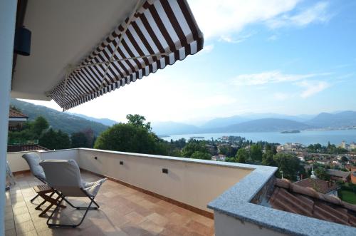 a balcony with a view of the water and mountains at Le Terrazze, Via Selvalunga 1, Stresa in Stresa