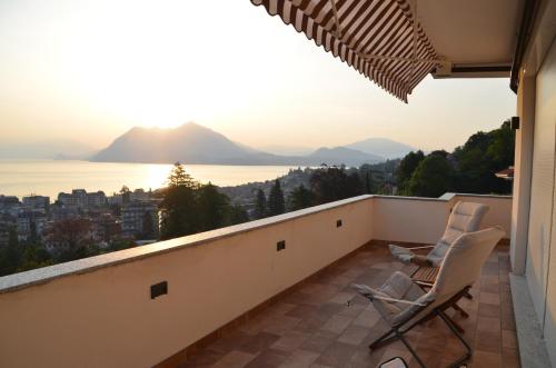 a balcony with two chairs and a view of the ocean at Le Terrazze, Via Selvalunga 1, Stresa in Stresa