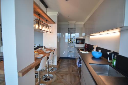 a kitchen with a long counter and a counter top at Le Terrazze, Via Selvalunga 1, Stresa in Stresa