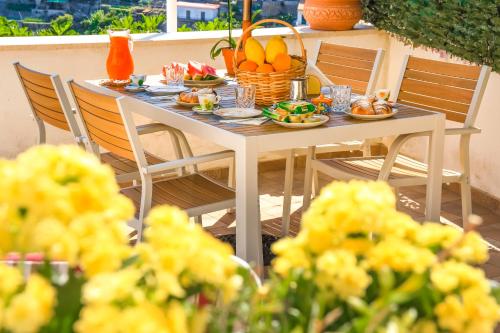 a table with plates of food and fruit on it at Villa Mare in Amalfi
