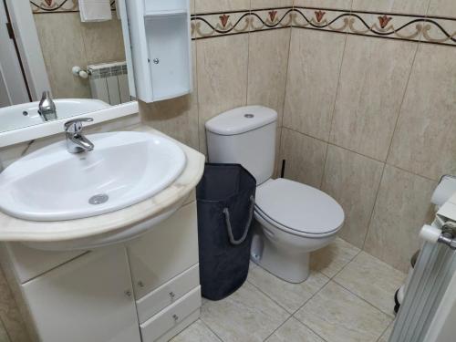 a bathroom with a white toilet and a sink at Casa da Encosta Douro Valley in Pinhão