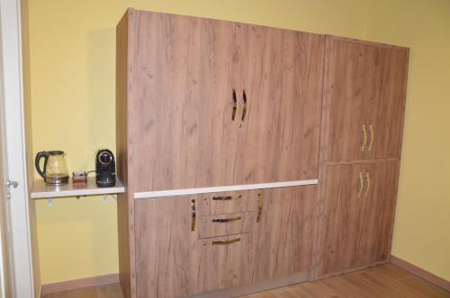 a large wooden cabinet in the corner of a room at I fiori del Pollino - Guest House in San Severino Lucano