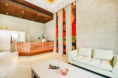 a living room with a couch and a table at La Sagrita in New Delhi