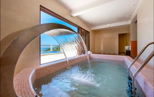 a swimming pool with a water fountain in a building at Sunbreeze Delux Vilas in Budva