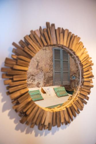 a mirror reflecting a bedroom with a bed and a window at Rota VMF - Redondo in Redondo