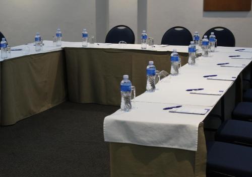 a row of tables with bottles of water on them at Blue Lagoon Hotel and Conference Centre in East London