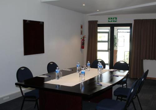 a meeting room with a table with bottles of water on it at Blue Lagoon Hotel and Conference Centre in East London