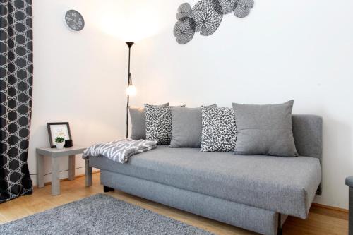 a living room with a couch and a table at Modern Balcony Apartment with Pool close to Lake in "Donaustadt" in Vienna