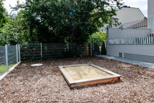 a backyard with a trampoline on the ground at Modern Balcony Apartment with Pool close to Lake in "Donaustadt" in Vienna