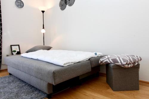a bed in a room with a lamp and a rug at Modern Balcony Apartment with Pool close to Lake in "Donaustadt" in Vienna
