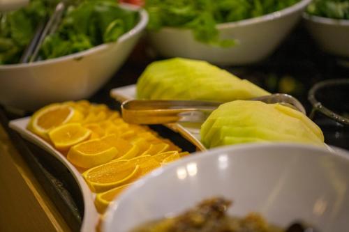 a table topped with bowls of fruit and vegetables at BEST GARDEN HOTEL in Istanbul