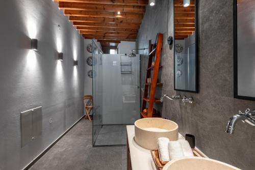 a bathroom with two sinks and a shower at Antique Villa in Líndos