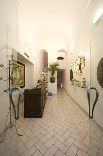 a museum with a hallway with a staircase and a room with at Palazzo Marzoli charme Resort - Small Luxury Hotel in Positano