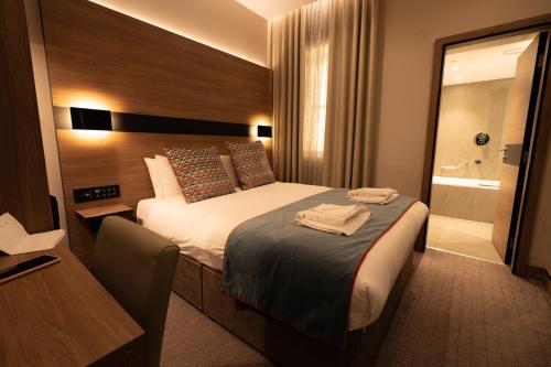 a hotel room with a bed and a bathroom at Oxford Hotel in London