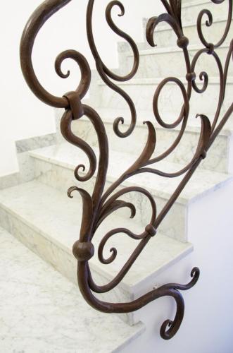 a metal gate with stairs in the background at Palazzo Marzoli charme Resort - Small Luxury Hotel in Positano