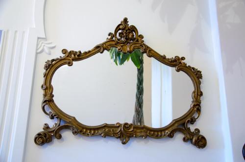 a mirror on a wall with a plant in it at Palazzo Marzoli charme Resort - Small Luxury Hotel in Positano