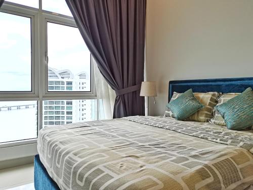 a bedroom with a bed with a large window at Southbay Plaza Condominium in Bayan Lepas