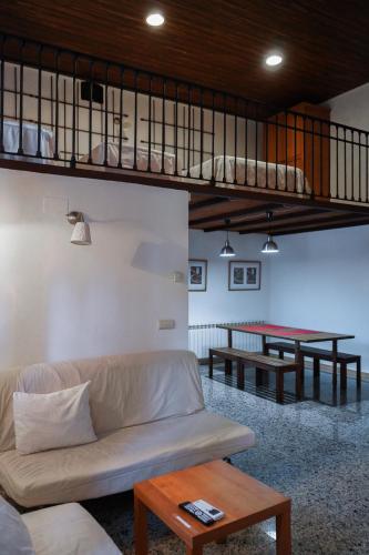 a living room with a couch and a ping pong table at Fabrica de Harina in Ventas con Peña Aguilera