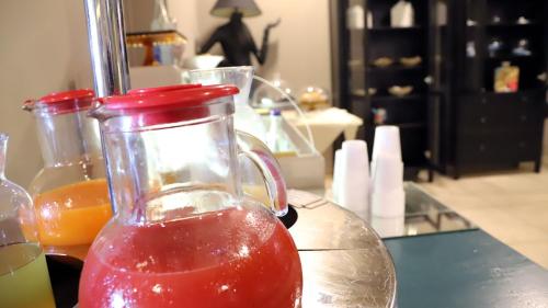 a jug of red juice sitting on a table at Hotel Europa in Ancona