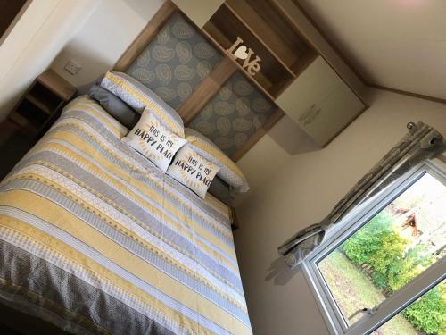a bedroom with a bed and a window at Lakes Breaks - 6 Meadows in Tattershall