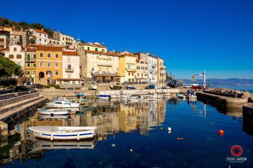 a group of boats docked in a harbor with buildings at Villa Zita Lovran in Opric