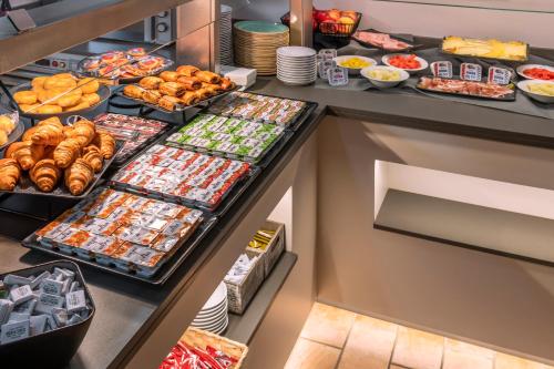 a buffet of food in a hotel room at GHT Miratge - Only Adults 18 and up in Lloret de Mar