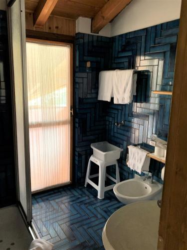a bathroom with a sink and a toilet at Residence Trunka Lunka in Cavalese