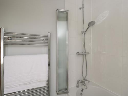 a shower with a glass door next to a shower at Kingfisher, 2 The Old Stables in Witney