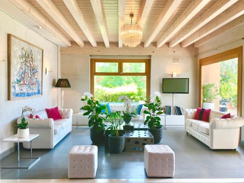 a living room with two couches and a tv at Relais Le Betulle in Conegliano