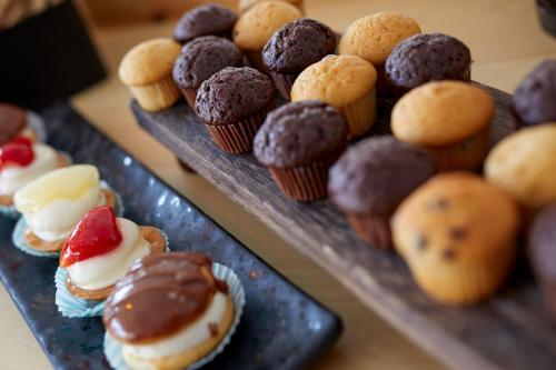 a bunch of different types of pastries on plates at Blue Sea Hotel in Kamari