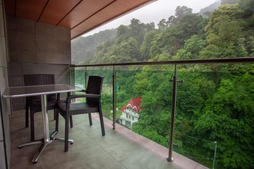 a balcony with a table and chairs and a view at Neptun Palace Kvariati in Kvariati