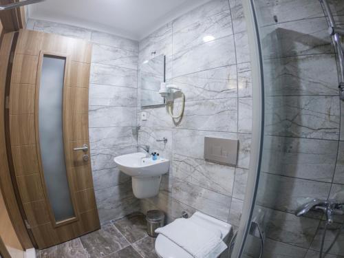 a bathroom with a shower and a toilet and a sink at Seher HOTEL in Istanbul