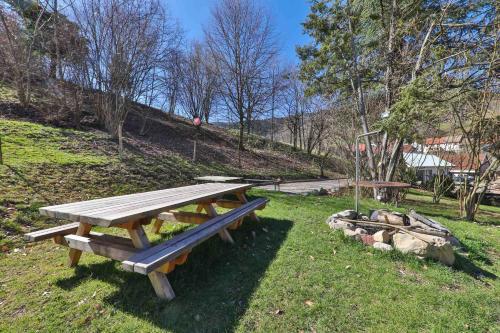 a picnic table in the grass in a park at Locations des 3 sommets avec Sauna et Spa en Alsace in Sondernach