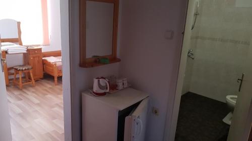 a bathroom with a sink and a toilet in a room at Kirovi House - guest rooms in Tsarevo