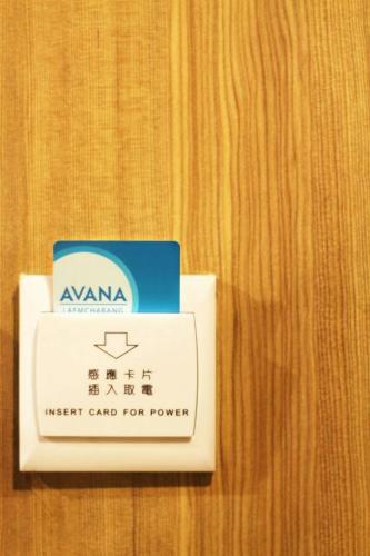 a energy card for power is sitting on a table at Avana Laem Chabang Boutique Hotel in Ban Laem Chabang