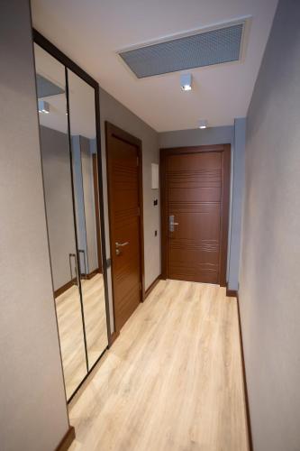 a hallway with wood floors and a door at Neptun Palace Kvariati in Kvariati