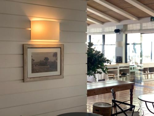 a light on the wall of a building with a table at El Far Hotel Restaurant in Llafranc