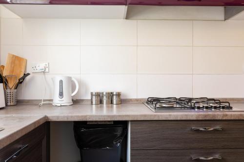 a kitchen with a stove and a counter top at Pinewood in St Julian's