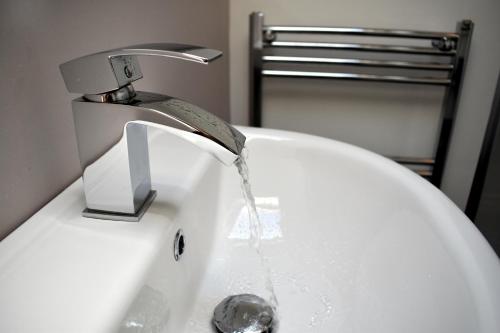 a sink with water coming out of a faucet at The Meadows B&B in Moville
