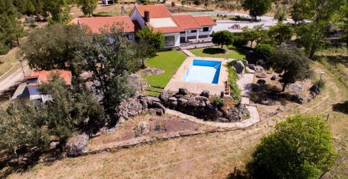 an aerial view of a home with a swimming pool in a yard at Quinta do Prado Verde in Vilar Formoso