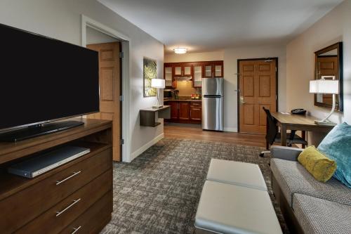 a living room with a couch and a flat screen tv at Staybridge Suites Missoula by IHG in Missoula