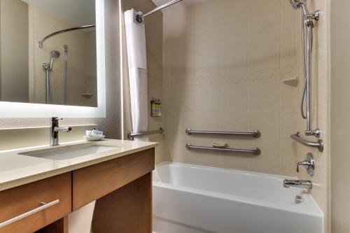 a bathroom with a sink and a tub and a shower at Staybridge Suites Missoula by IHG in Missoula