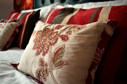 a row of pillows sitting on a bed at The Meadows B&B in Moville